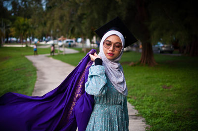 Portrait of young woman standing outdoors