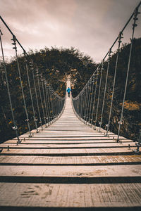 Rear view of woman on footbridge