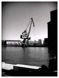 Silhouette of cranes at harbor