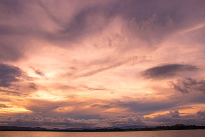 Low angle view of dramatic sky over sea during sunset