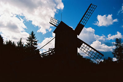 Low angle view of traditional windmill against sky