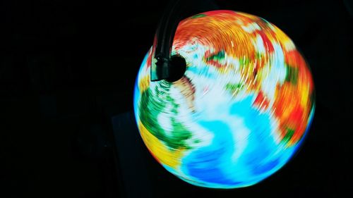 Close-up of illuminated globe against black background