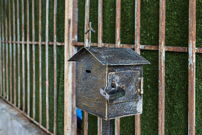 Close-up of bird perching on birdhouse