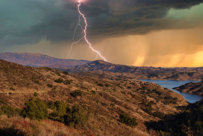 Lightning over mountain during sunset