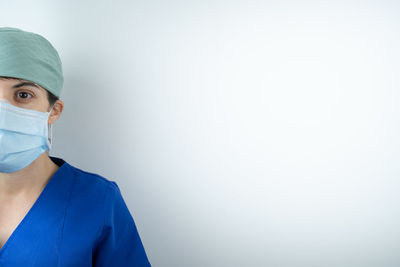 Portrait of woman standing against blue sky