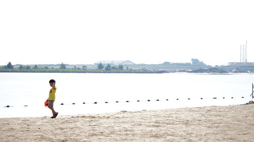 Full length of woman standing on shore