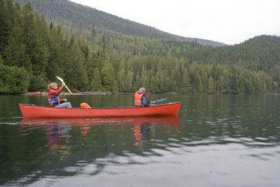 Siblings canoeing on williams lake at wells gray provincial park