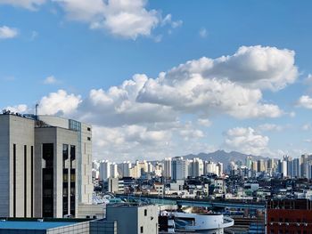 Buildings in city against sky