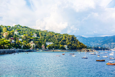 Fishing boats moored on water in harbor of ligurian and mediterranean sea near 