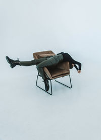 High angle view of man on chair against white background