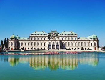 View of buildings against clear blue sky