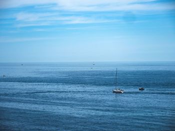 Sailboats sailing in sea against sky