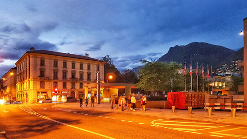 Group of people walking on road at night