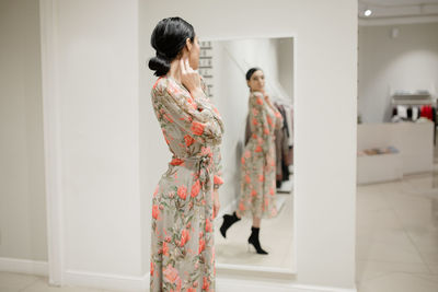 Rear view of woman standing in corridor