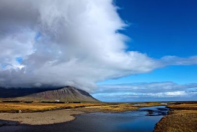 Scenic view of mountains against cloudy sky