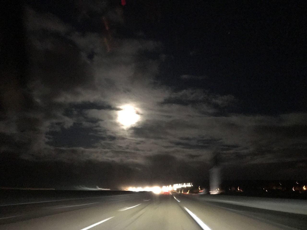 ILLUMINATED ROAD AGAINST SKY AT SUNRISE