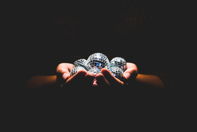 Close-up of human hand against black background