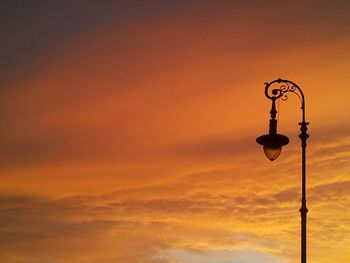Low angle view of lamp post against sky during sunset