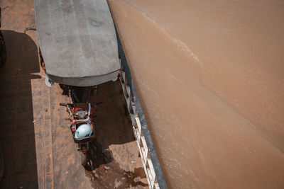 High angle view of nautical vessel on sea by wall