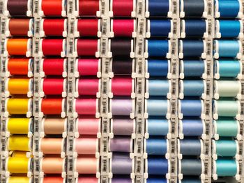 Full frame shot of colorful thread spools for sale in store