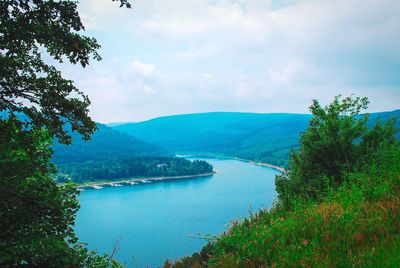 Scenic view of lake and mountains against sky