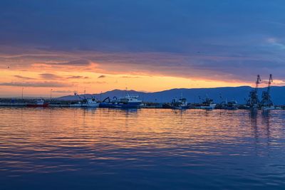 Sailboats in marina at sunset