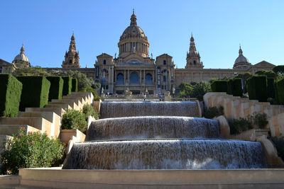 Low angle view of fountain outside historic building