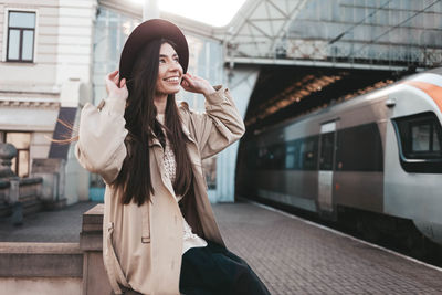 Woman standing at railroad station