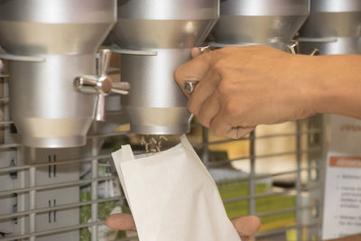 Midsection of man working in kitchen