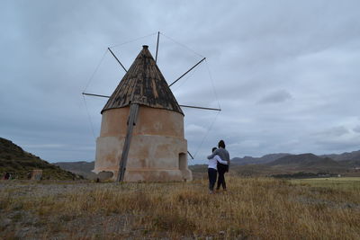 Low angle view of man standing on field against sky
