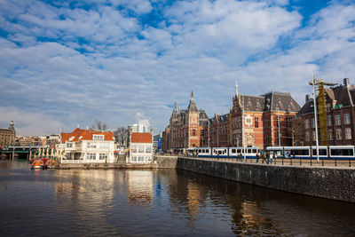 Canals, central railway station and tram at the old central district of amsterdam