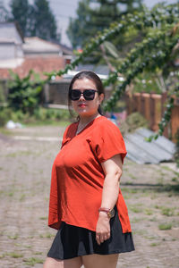 Portrait of young woman standing outdoors