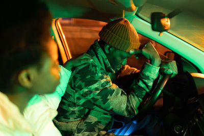 Stressed man with woman sitting in car