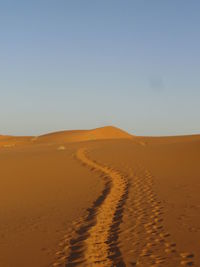 Scenic view of desert against clear sky