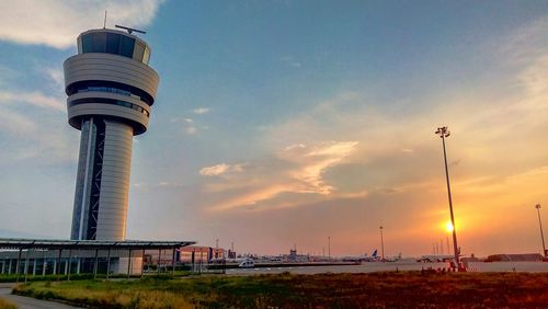 Lighthouse against sunset sky