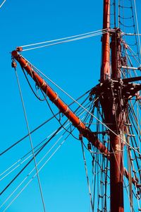 Low angle view of sailboat against clear blue sky