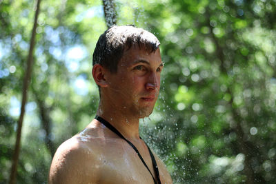 Close-up of man standing outdoors during rain