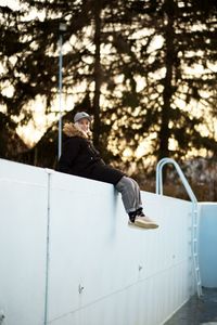 Rear view of woman sitting on slide at playground