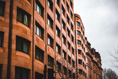Low angle view of building against cloudy sky