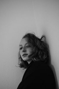 Low angle portrait of woman against wall