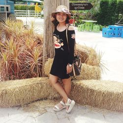 Portrait of smiling woman standing against plants