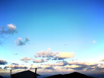 Scenic view of mountains against cloudy sky