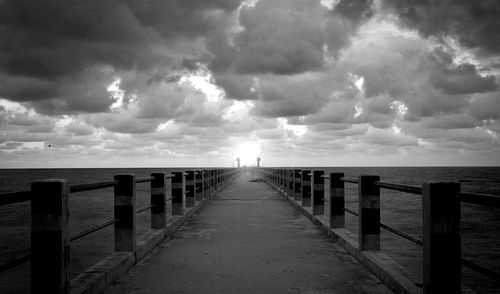 Pier over sea against sky