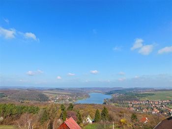 Scenic view of town against blue sky