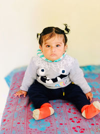 Portrait of cute baby boy sitting at home