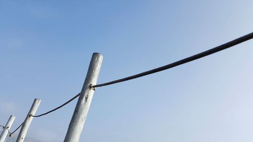 Low angle view of cables against clear blue sky