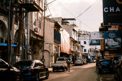 Cars on street amidst buildings in city