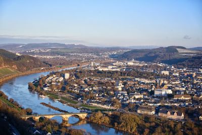 High angle view of river amidst buildings in city against sky