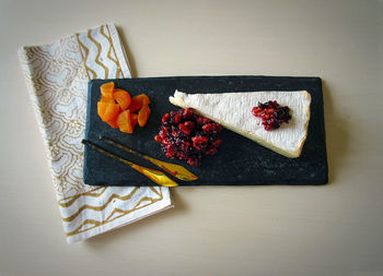 Directly above shot of brie with cranberry chutney on granite