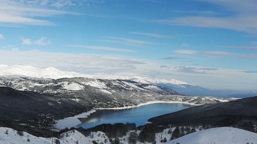 Scenic view of snowcapped mountains against blue sky